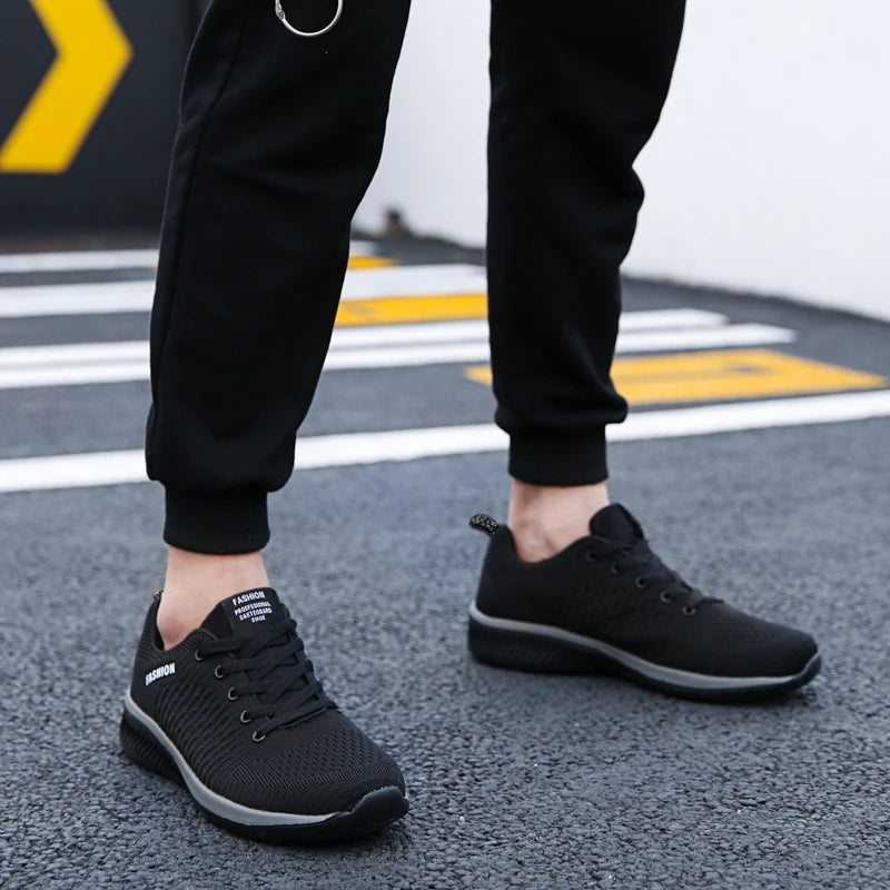 Herr- och dam-sneakers i stickat material, andningsbara sportskor för löpning, promenader och gym